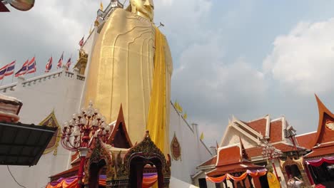 Buddhism:-Golden-Buddha-Statue-with-sky-in-the-background-tilt-up-shot