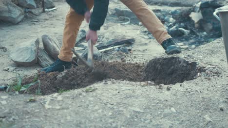 Afghan-refugee-digging-a-hole-in-the-olive-grove-overspill-of-Moria-Refugee-Camp-on-Lesvos-Island