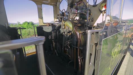 Close-up-of-flames-in-firebox-in-cab-of-LYD-narrow-gauge-steam-engine-building-steam-before-departure,-Ffestiniog-Railway,-Porthmadog-Harbour-Railway-Station,-Snowdonia,-Wales---SLOMO-60fps