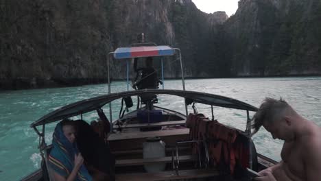 Friends-sitting-in-boat-in-a-beautiful-spot-in-asia