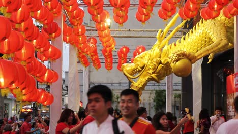 Large-Crowd-Walking-Underneath-Red-Lanterns,-Chinese-New-Year