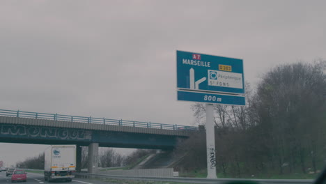 Guide-road-sign-on-a-highway-near-Marseille,-France,-from-inside-a-car-view