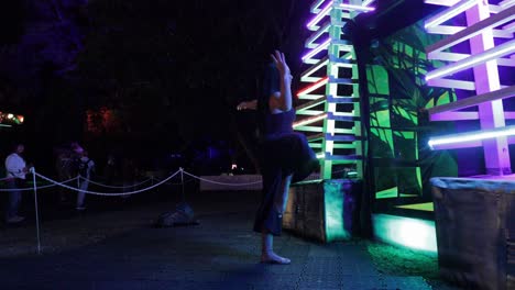 Empowered-barefoot-female-dancer-moving-with-beauty-and-grace-alongside-light-installation-in-nocturnal-botanic-garden---VIVID-Sydney---4K,-59