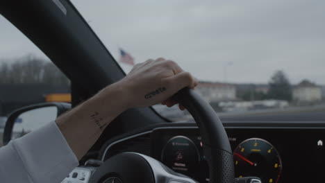 Mercedes-Benz-cockpit,-close-up-on-driver-hand-and-steering-wheel-while-driving