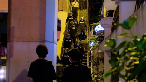 Thai-Policemen-Wearing-Facemask-And-Bulletproof-Vest-With-Riot-Shield-Walking-Down-The-Stairs-And-Responding-To-Protest-Against-The-Government