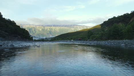 A-man-standing-on-medieval-Kadiut-bridge-Vjosa-river-Permet,-Albania