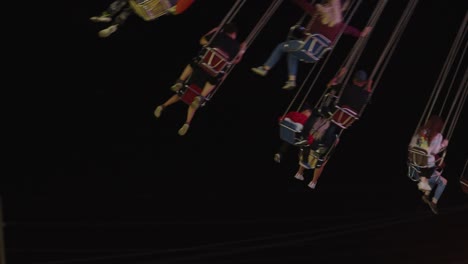 Following-a-young-group-of-people-spinning-around-on-a-flying-chair-swing-type-of-carousel-ride-at-a-local-annual-funfair-carnival-organised-in-Regina-City-in-Canada