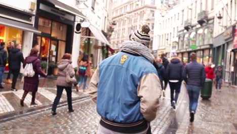 Close-up-panning-shot-of-a-vintage-record-store-window-displaying-vinyl-records-in-Brussels,-Belgium