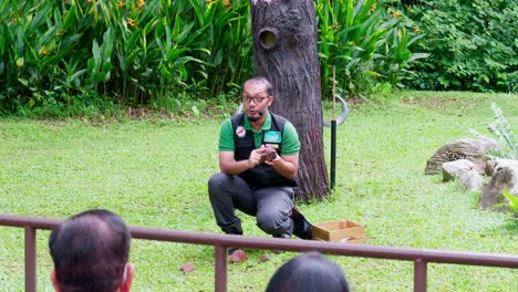 Guardián-Del-Zoológico-Y-Entrenador-Con-Búho-En-La-Mano-Explicando-Al-Público-Sobre-Los-Animales