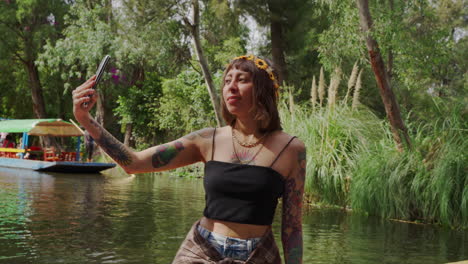 Mexican-woman-takes-photos-on-boat-at-Embarcadero-Nuevo-Nativitas-Xochimilco