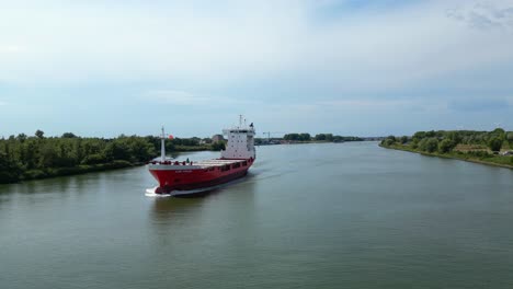 Aerial-Parallax-Across-Forward-Bow-Of-A2B-Proud-Cargo-Ship-Sailing-Along-Oude-Maas-In-Zwijndrecht