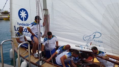 Latin-sail-boat-where-its-sailors-prepare-the-sails-to-set-sail-from-the-port-on-a-sunny-day-in-Las-Palmas-de-Gran-Canaria