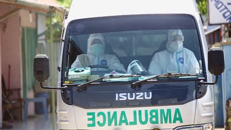 Emergency-ambulances-and-health-workers-pick-up-patients-by-crossing-residential-areas-in-West-Java,-Indonesia