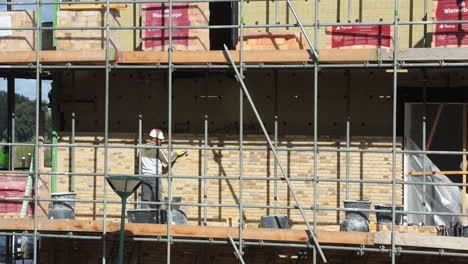 Closeup-timelapse-at-construction-site-with-brick-layers-building-up-the-facade-exterior-of-a-home