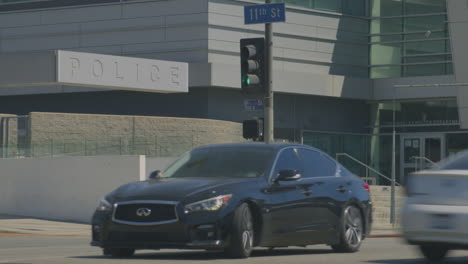 Static-shot-of-cars-passing-the-downtown-police-headquarters