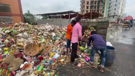 men-raking-garbage-out-of-the-wagon-they-hauled-to-the-dump