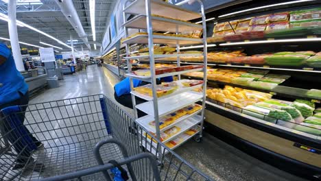 POV-while-pushing-a-cart-through-Walmart-past-the-meat-counter