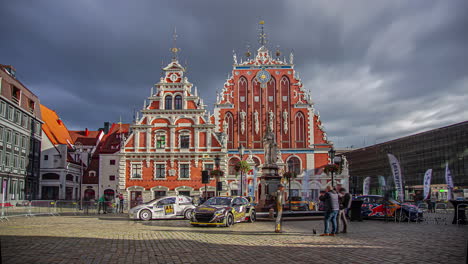 Shot-of-racing-car-on-display-in-front-of-a-old-historical-building-in-Riga,-Latvia-during-RX-World-Rally-Cross-Championship-on-a-cloudy-day