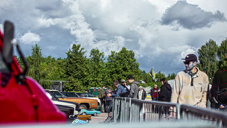 Timelapse-shot-of-crowd-of-fans-watching-the-cars-on-display-during-RX-World-Rally-Cross-Championship-in-Riga,-Latvia-at-daytime