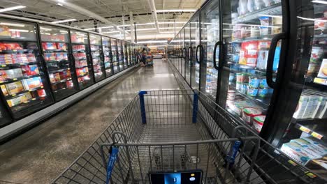 POV-while-pushing-a-cart-through-Walmart-freezer-section-and-into-the-fresh-meat-section