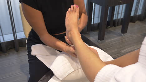 Female-Masseuse-Massaging-Leg,-Calves-and-Foot-of-Unrecognizable-Woman