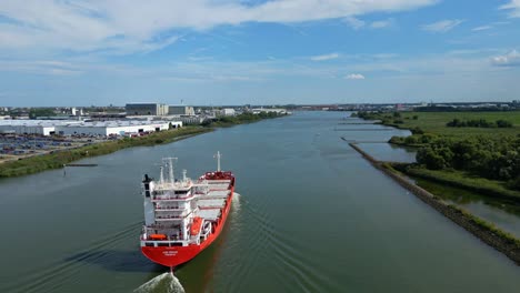 Aerial-Descending-Towards-Stern-Of-A2B-Proud-Cargo-Ship-Sailing-Along-Oude-Maas-In-Zwijndrecht