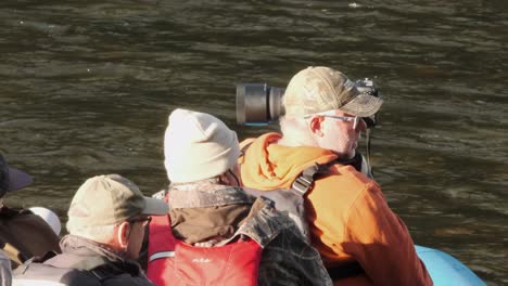 Tourism-guests-on-river-raft-prepare-to-observe-bears-on-float-trip