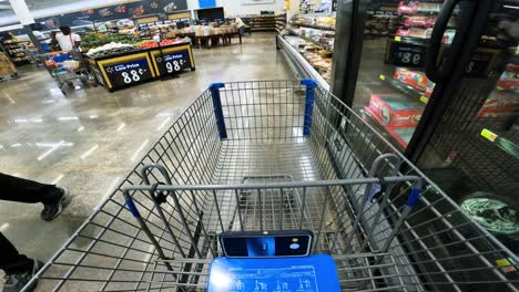 POV-while-pushing-a-cart-thru-the-produce-and-past-the-bakery-goods-in-Walmart