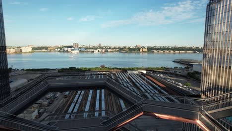 An-aerial-view-of-the-Vessel,-known-as-the-Hudson-Yards-Staircase-designed-by-Thomas-Heatherwick-on-a-sunny-day