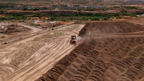 Dump-Truck-driving-in-gravel-pit-area-at-Bluffdale-Utah---Aerial-Orbit