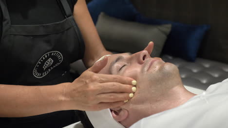 Handsome-Man-Getting-A-Relaxing-Facial-Massage-In-Spa