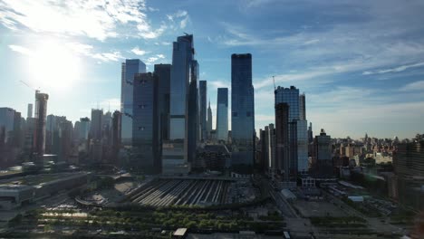 An-aerial-view-of-Hudson-Yards-and-the-Vessel-from-over-the-Hudson-River-on-a-sunny-day