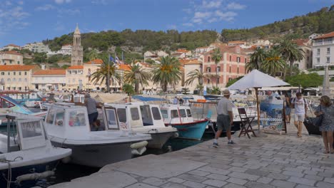 Two-friends-talking-along-the-River-in-Hvar,-Croatia