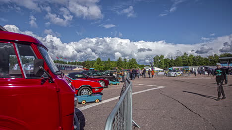 Timelapse-shot-of-group-of-fans-walking-around-watching-cars-on-display-during-RX-World-Rally-Cross-Championship-in-Riga,-Latvia-at-daytime