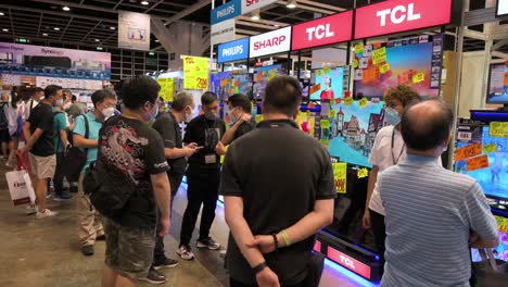 Chinese-retail-buyers-shops-for-TCL,-Philips,-and-Sharp-Televisions-at-the-Hong-Kong-Computer-and-Communications-Festival-as-people-buy-discounted-electronic-products-in-Hong-Kong