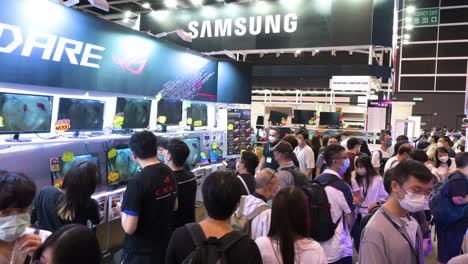 Crowds-of-Chinese-retail-customers-queue-in-line-as-they-browse-and-purchase-Asus-brand-discounted-electronic-products,-such-as-hard-drives,-TVs,-and-computers,-in-Hong-Kong