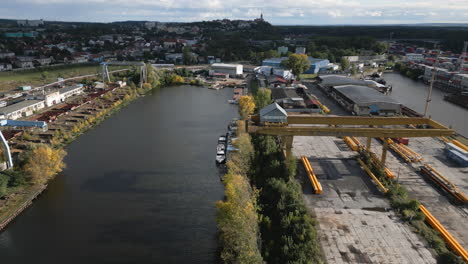 Aerial-view-of-the-cargo-port-area-from-containers,-cranes,-and-trucks