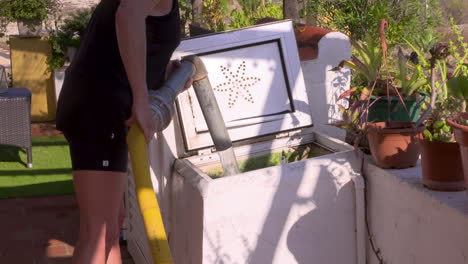 footage-of-a-person-replenishing-the-house's-dried-up-water-supply-with-the-fire-department's-water-hose