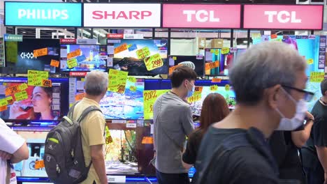 Chinese-retail-customers-shop-for-TCL,-Philips,-and-Sharp-televisions-displayed-for-sale-at-the-Hong-Kong-Computer-and-Communications-Festival-as-people-buy-discounted-electronic-products