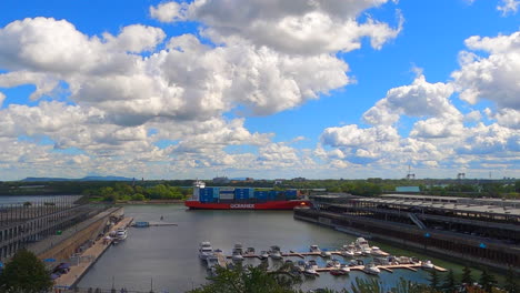 Cargo-Boat-Ferry-Sailing-on-River-Canal-next-to-Marina-at-Montreal-Port-Harbor-Canada,-Panoramic-View-of-Pier-Docks-and-Yachts-on-Water,-Freight-Transport-and-Tourism-Location