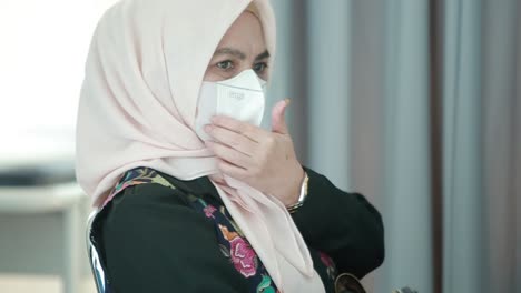 An-elderly-woman-in-a-mask-sits-in-line-at-a-hospital-to-get-a-virus-vaccination-during-a-pandemic-in-Indonesia