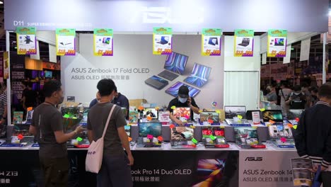 Chinese-retail-customers-are-seen-at-the-Asus-brand-booth-selling-laptops-as-visitors-browse-and-purchase-discounted-electronic-products,-such-as-hard-drives,-TVs,-and-computers,-in-Hong-Kong