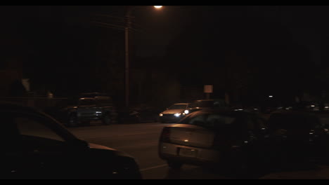 Revealing-shot-of-the-two-cars-driving-in-the-streets-near-Los-Angeles-City-Hall-at-night