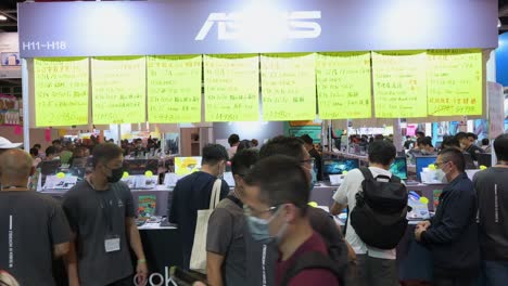 Chinese-retail-buyers-browse-and-purchase-Asus-brand-discounted-electronic-products,-such-as-hard-drives,-TVs,-and-computers,-in-Hong-Kong