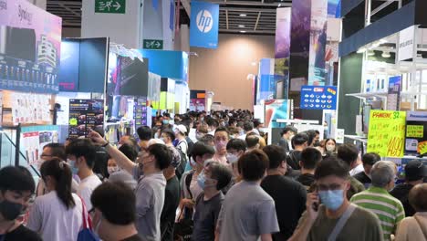 Large-crowds-of-Chinese-buyers-browse-and-walk-through-the-hallways-to-purchase-discounted-electronic-products,-such-as-hard-drives,-TVs,-and-computers,-in-Hong-Kong