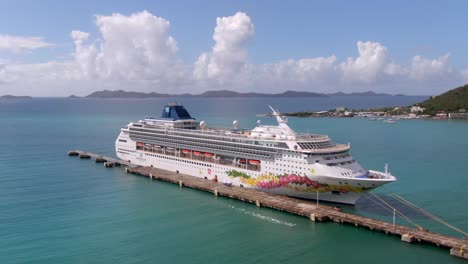 Aerial-orbit-around-docked-Norwegian-cruiseliner-Star-in-caribbean-waters