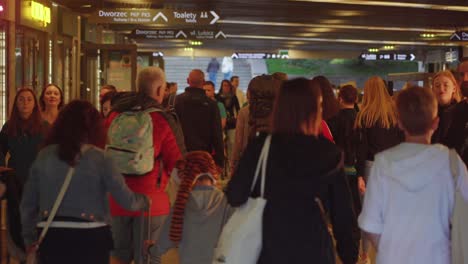 Video-of-a-crowd-of-people-strolling-through-underground-shopping-center-in-Kraków,-Poland