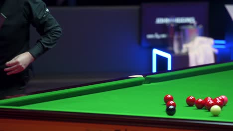 John-Higgins,-a-Scottish-professional-snooker-player,-plays-a-shot-as-he-strikes-a-ball-during-a-match-of-the-Hong-Kong-Masters-snooker-tournament-event