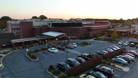 Rotational-aerial-shot-of-emergency-room-during-morning-sunrise