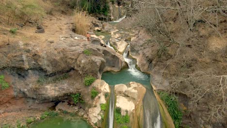 Tourists-Swim,-Hang-Out-And-Enjoy-The-View-Of-Waterfalls-At-Cascada-de-Comala-Park-Near-Chiquilistlan,-Jalisco,-Mexico
